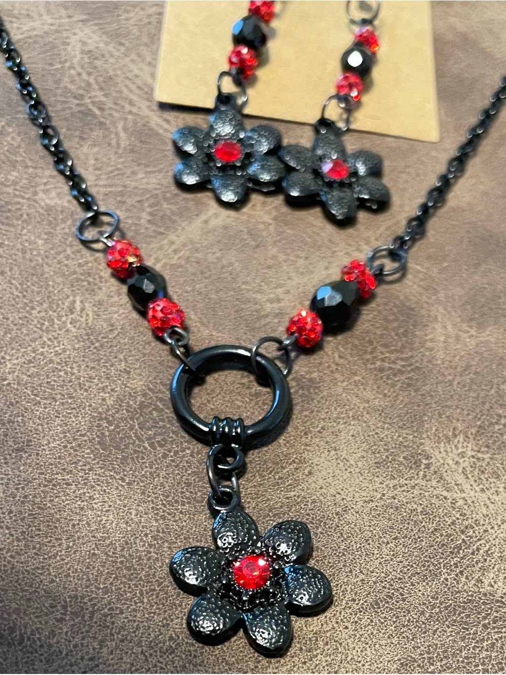 Black Metal Flower Pendant Necklace & Earrings with Red Crystal Accents